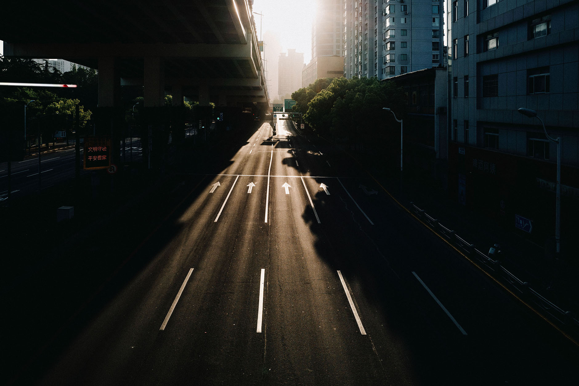 Morning light falling across an empty city road