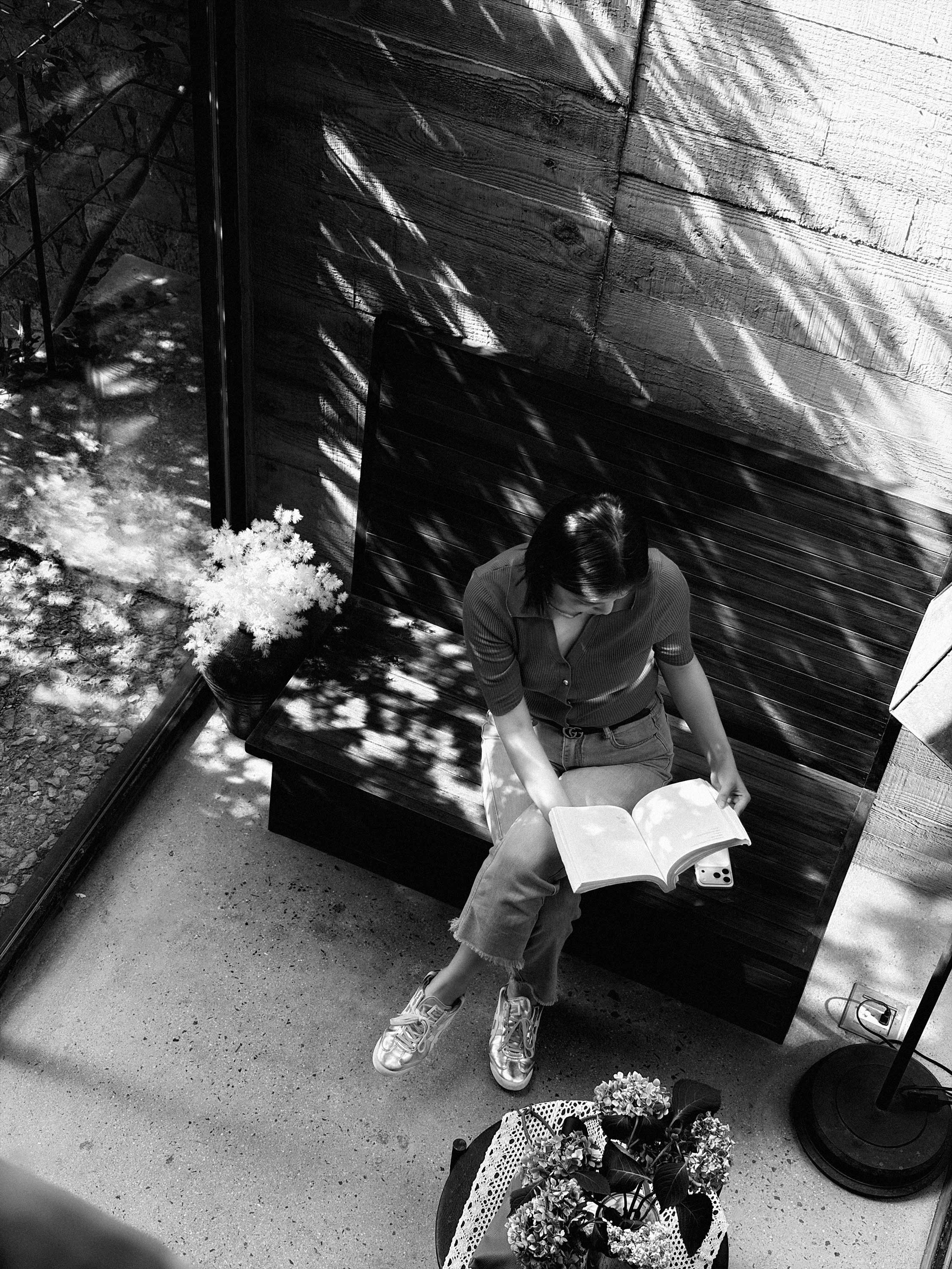 Woman reading in patterned sunlight in Zibo